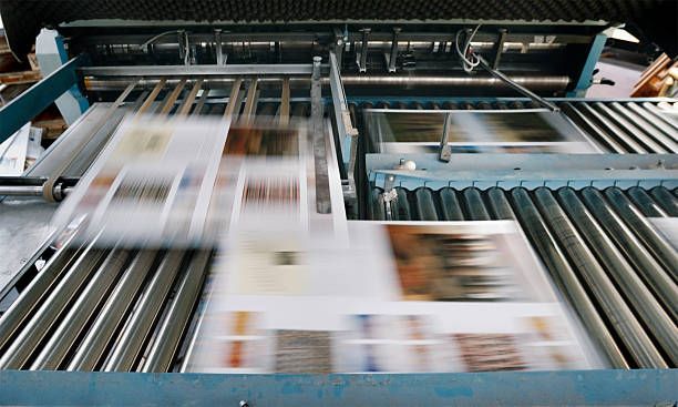 Printed sheets moving at speed through the folding and delivery section.